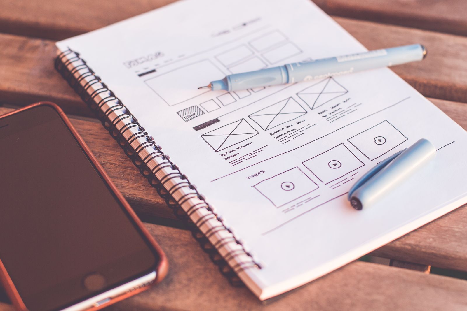 Website wireframe sketches planned on paper before any code is written